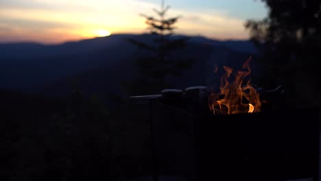summer-barbecue.-Flames-heating-up-grill.-sunset